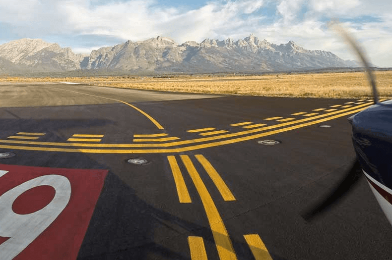 Fly Jackson Hole airport runway with grand teton views
